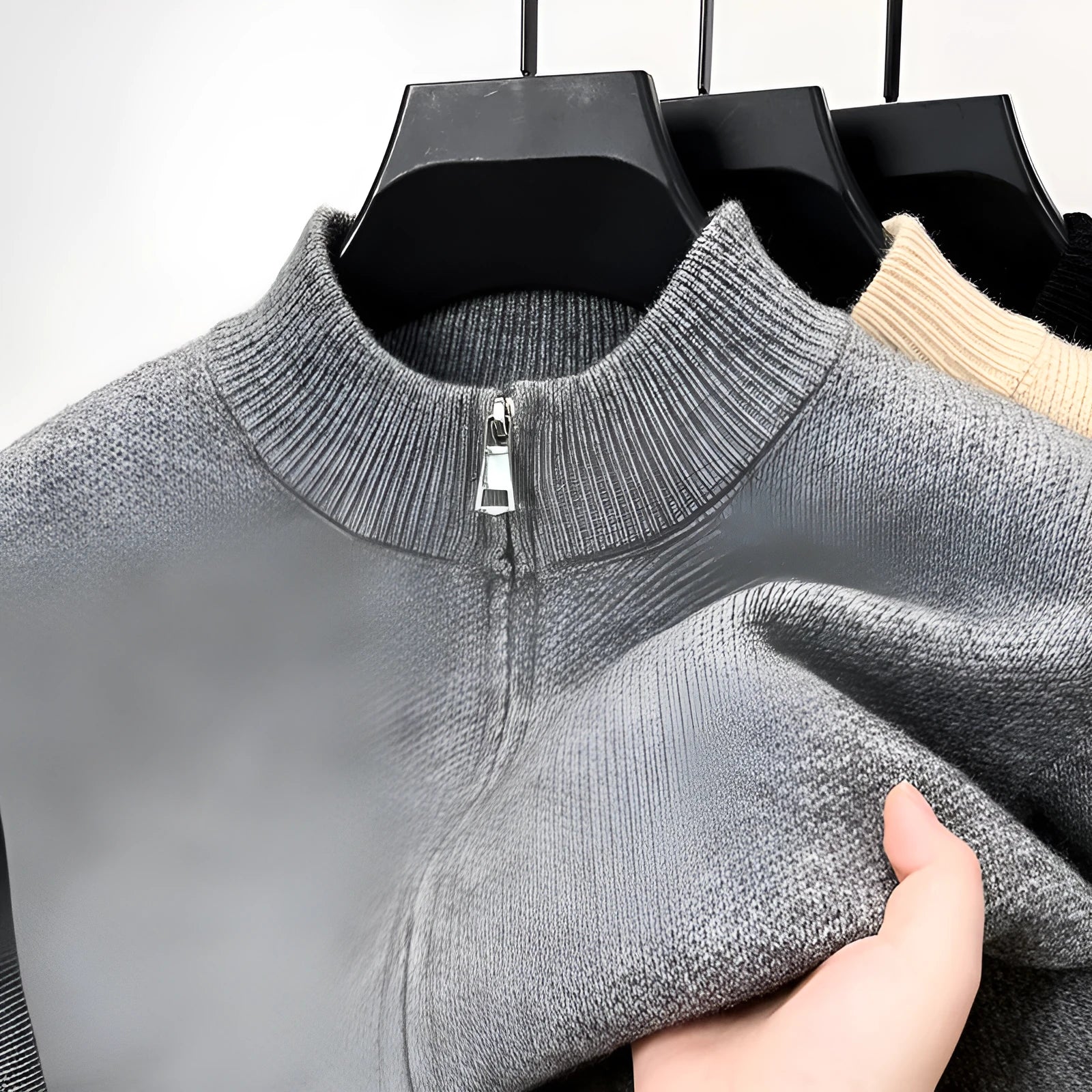 Men's black high collar zip-up knitted cardigan on a hanger, loose fit.