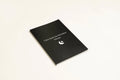 Black hardcover A5 dream journal notebook with plain paper pages open
