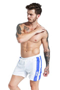 Blue men's slim fit polyester sports shorts with padding and a lace-up waistband on a white background.