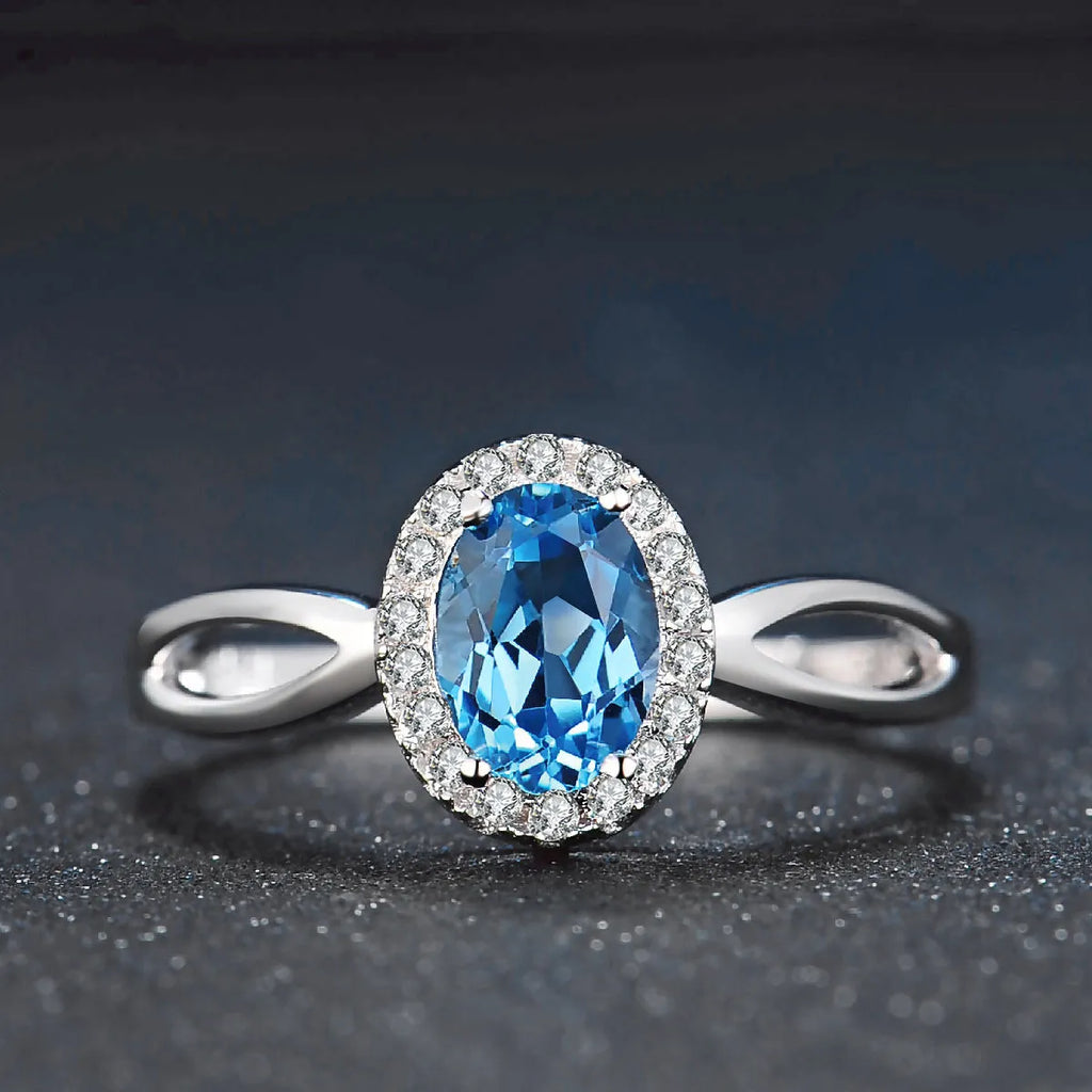 925 sterling silver jewellery set with blue topaz gems showing earrings, ring, pendant and necklace with geometric design