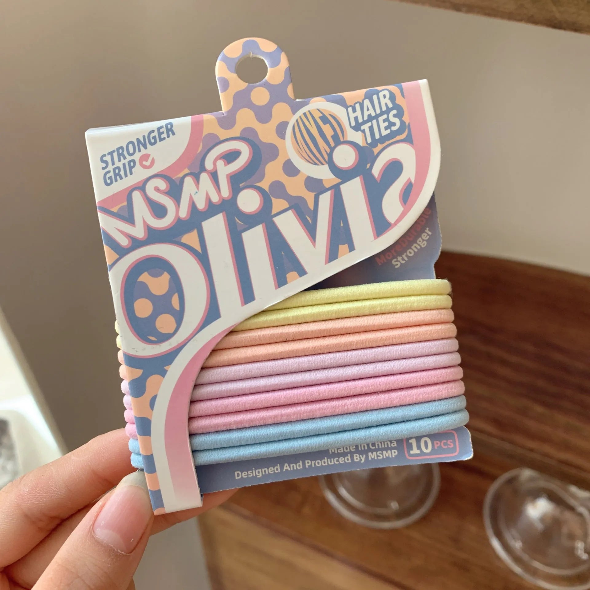 Assortment of candy coloured braided elastic hair bands on a white background.