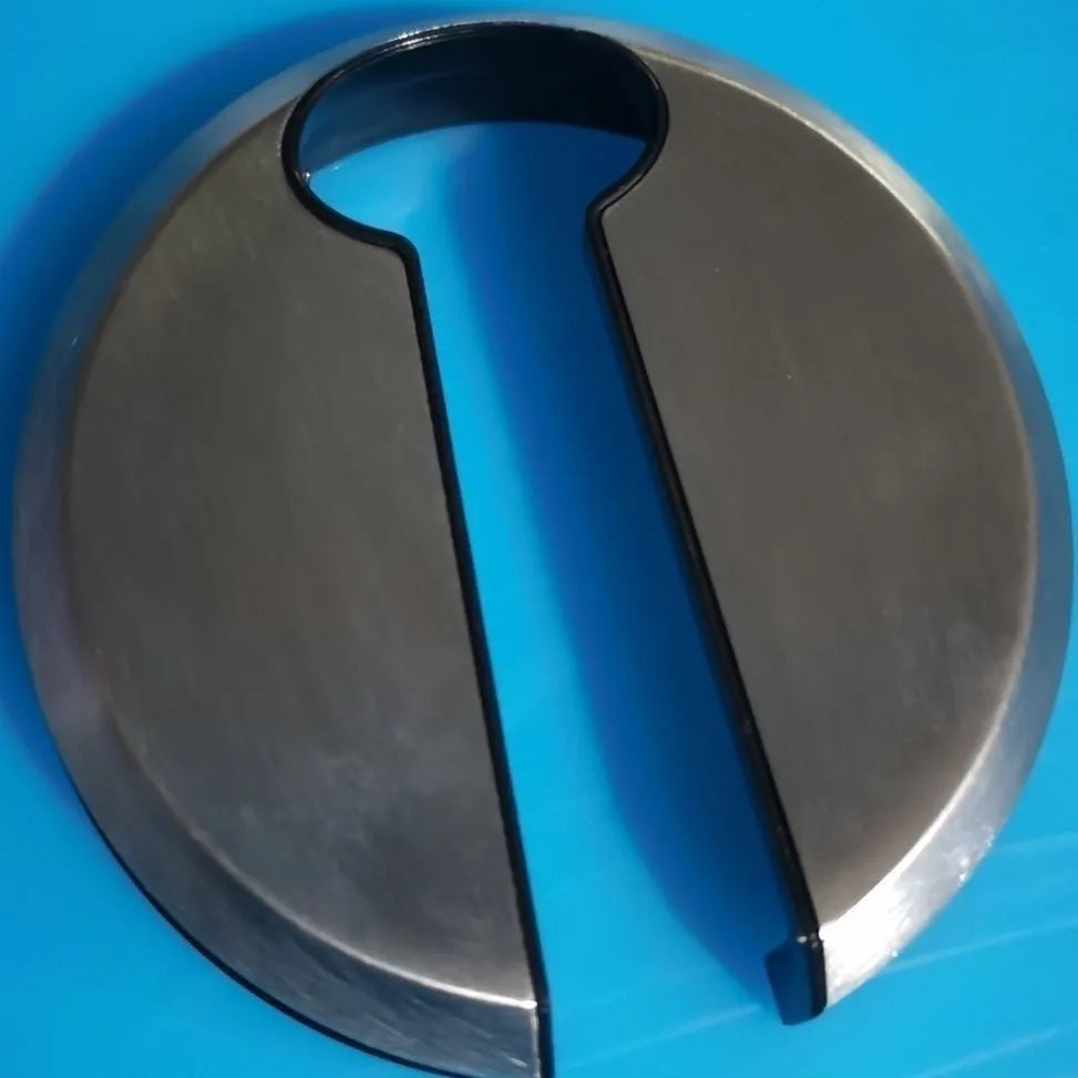 Stainless steel manual bottle opener and corkscrew tool on a kitchen counter.