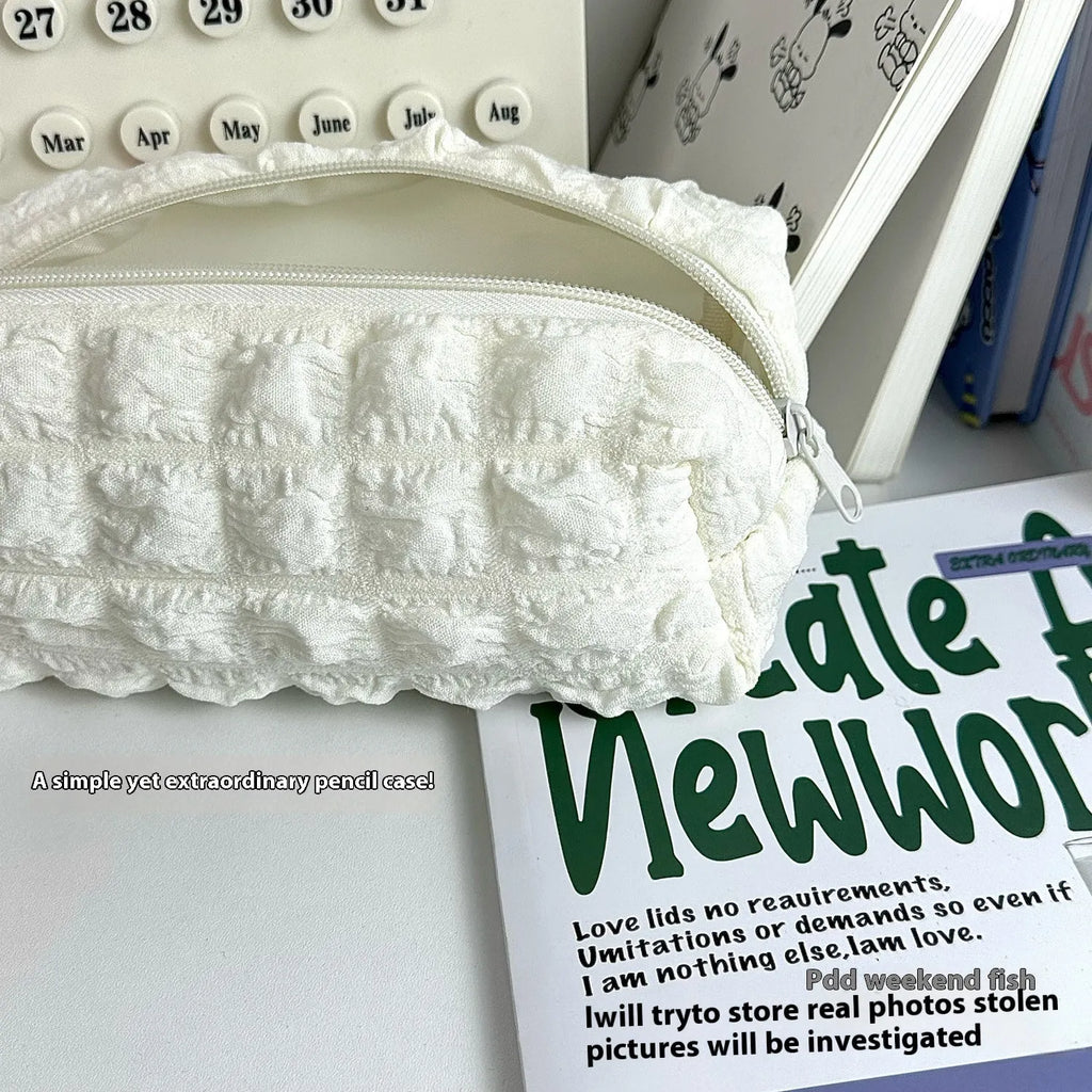 Cream puff design fabric pencil case in polyester material showing beige and black colour options