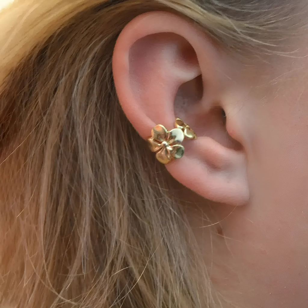Gold tone women's earrings with starfish and conch shell design