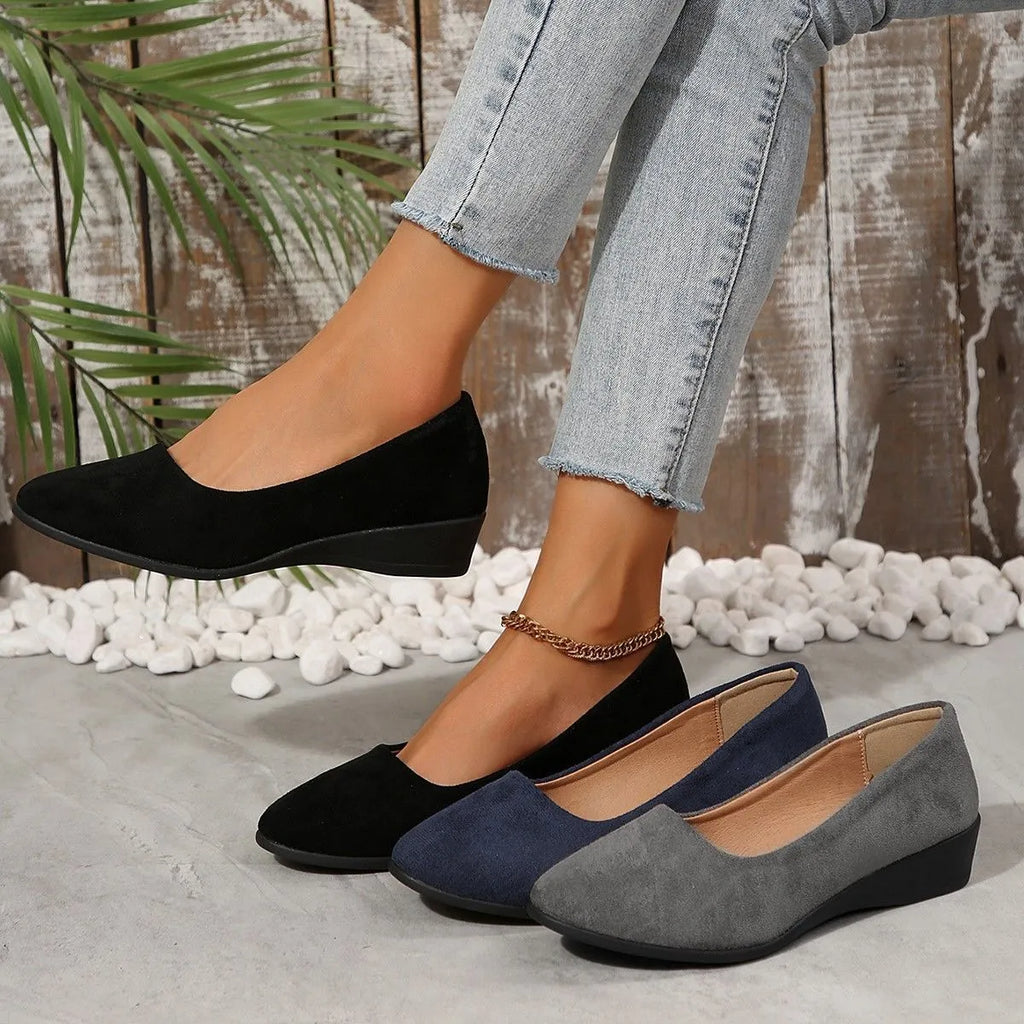 Women's suede wedge pumps in light brown with pointed toe and shallow mouth design.