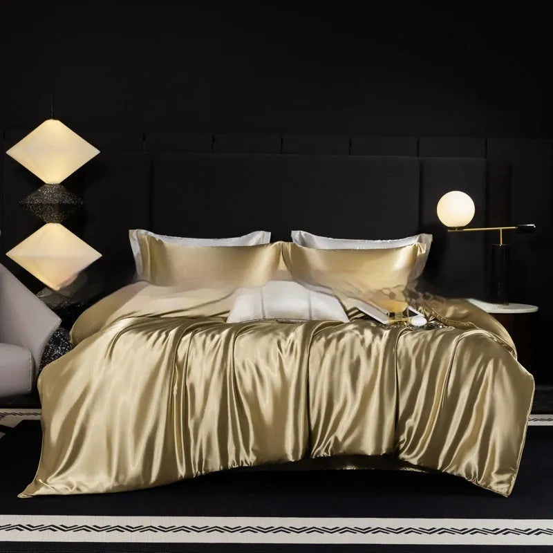 Silk four-piece bed sheet set in a solid colour on a bed, showing duvet cover and pillowcases.