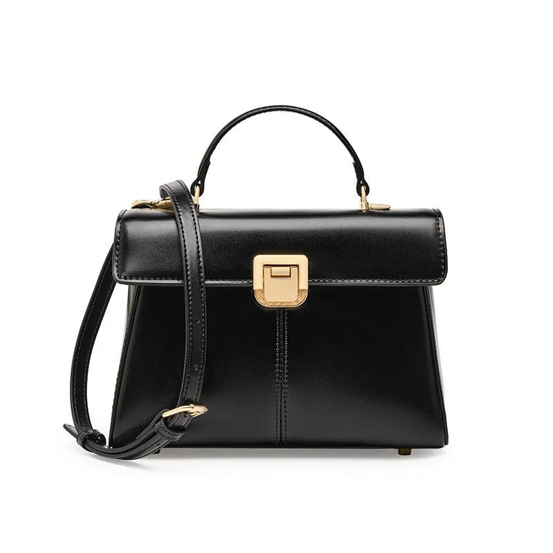 Black genuine leather shoulder bag with clasp closure showing internal compartments and adjustable strap