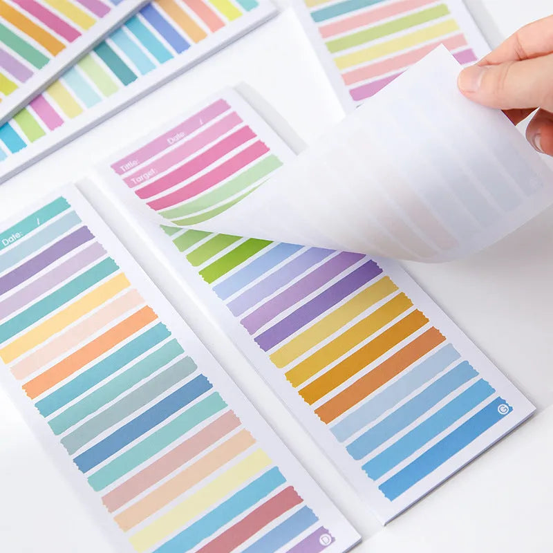 Cartoon character sticky note pad in a plastic storage box showing colourful striped and bear designs