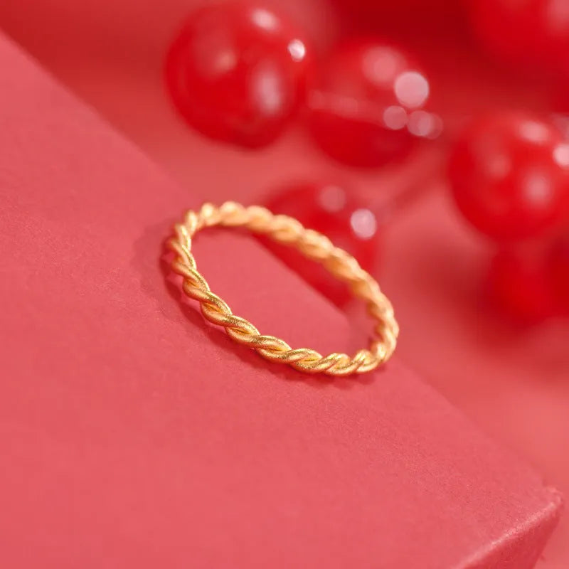 Brass gold plated women's ring showing simple bracelet and twist style options on a finger
