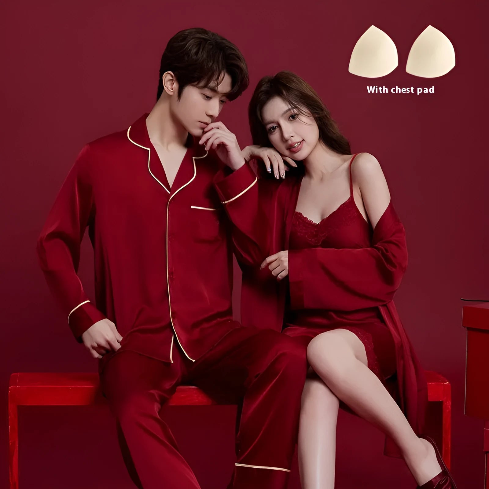 Red men's and women's long sleeve ice silk pyjama set laid flat.