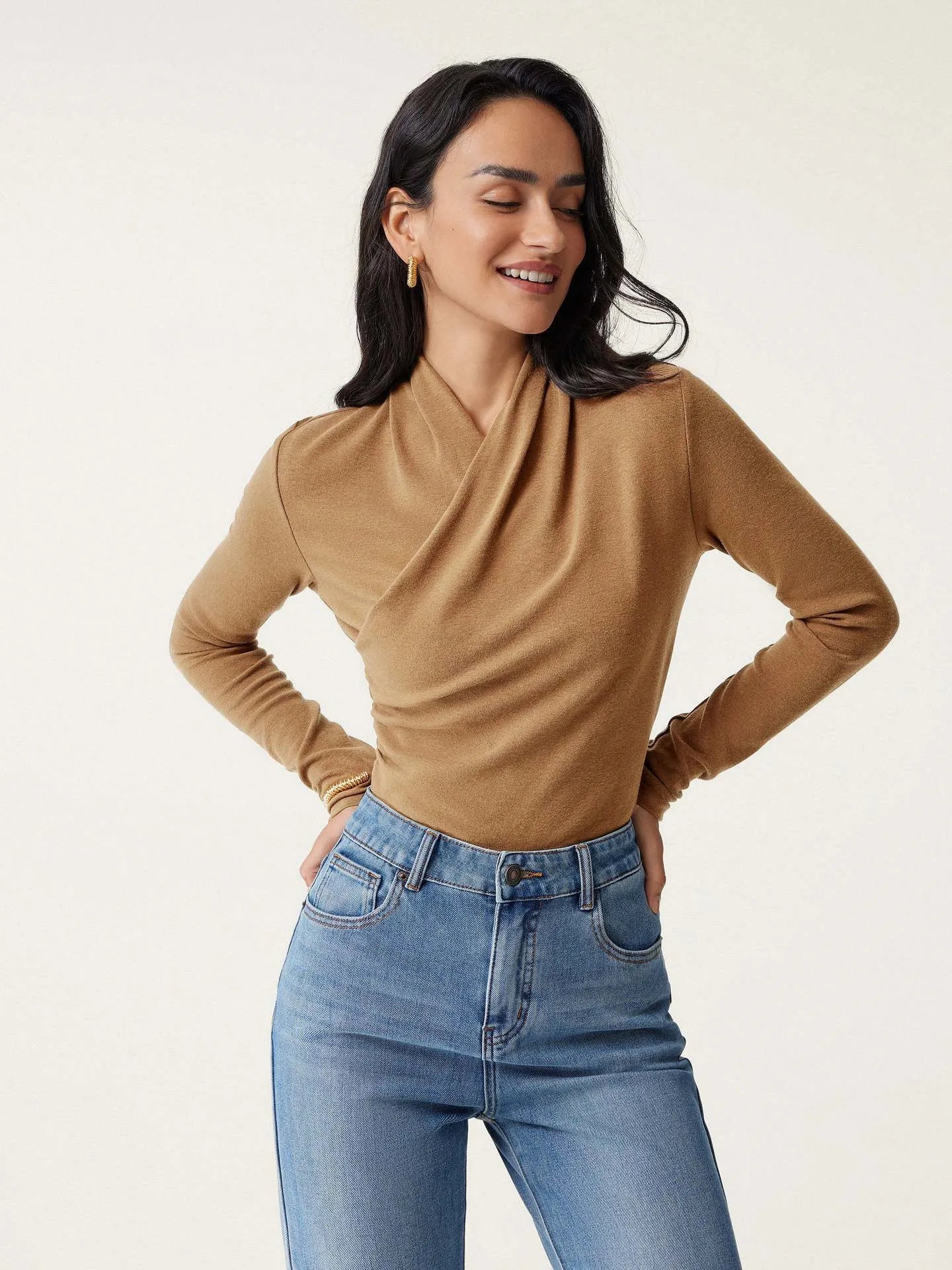 Camel-coloured slim-fit women's pullover sweater on a hanger.