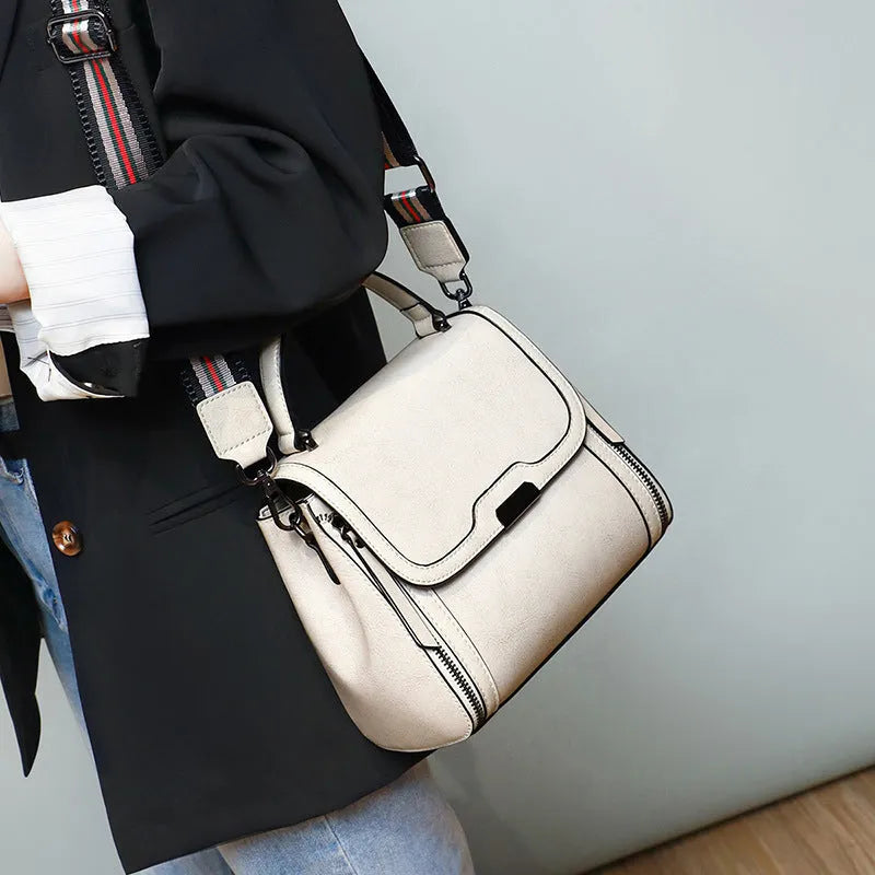 Women's genuine leather messenger bag in retro styling with multiple internal compartments