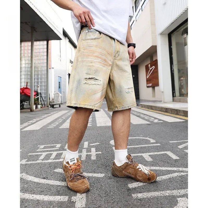 Light blue washed men's denim shorts with ripped details on a straight-leg cut
