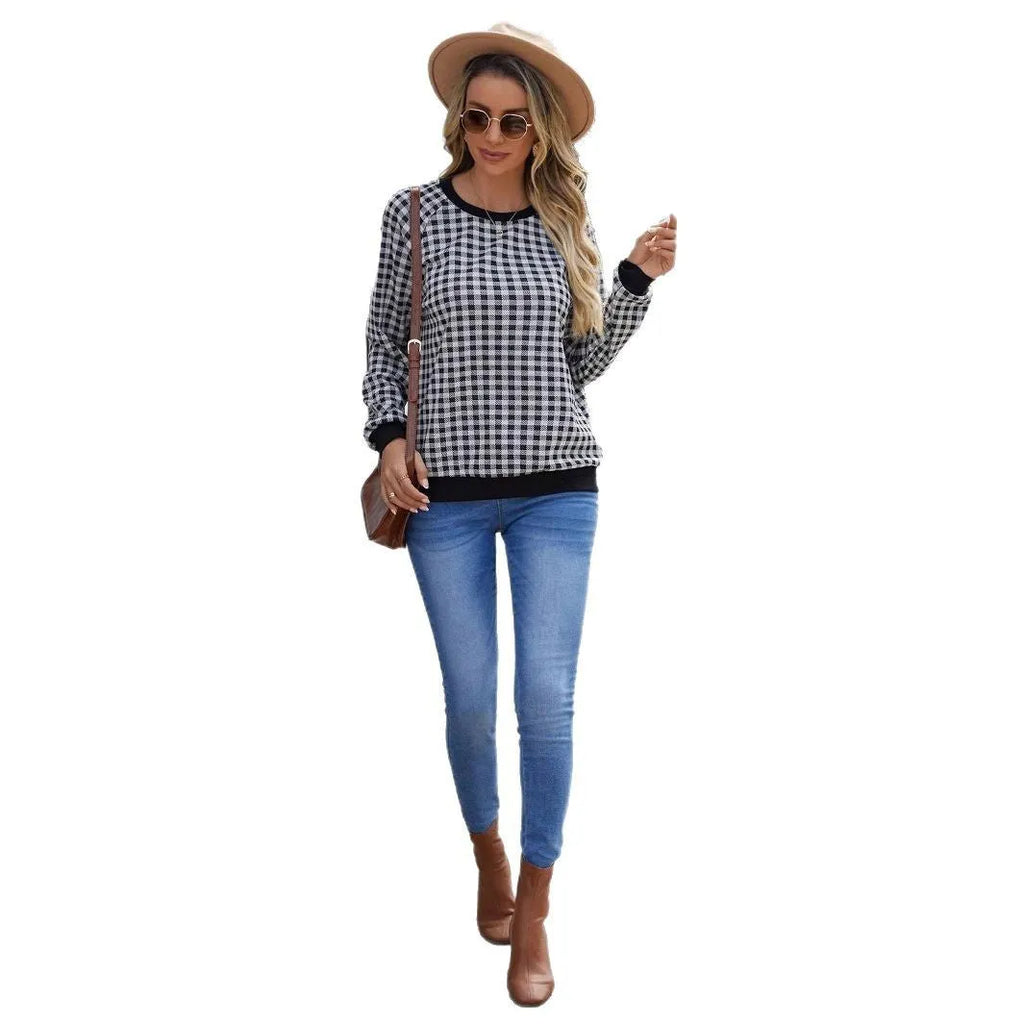 Black long sleeve pullover sweater with a Japanese plaid pattern, shown on a hanger.