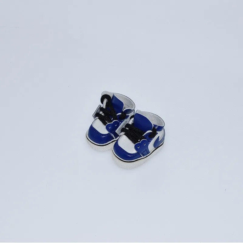 A pair of 17cm high PU replacement shoes for dolls in a selected style and colour.