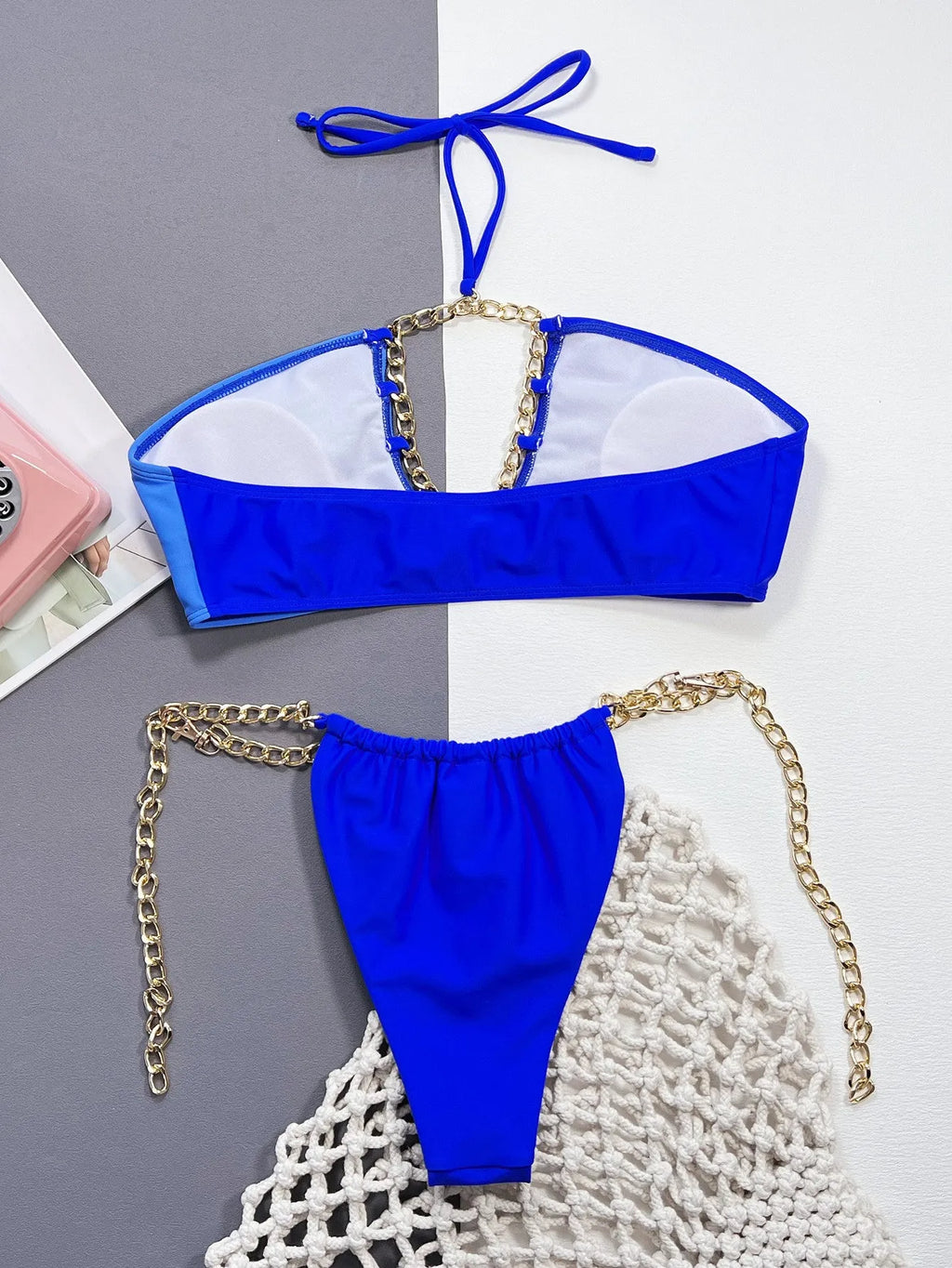 Solid blue women's nylon bikini swimsuit laid flat showing two-piece design