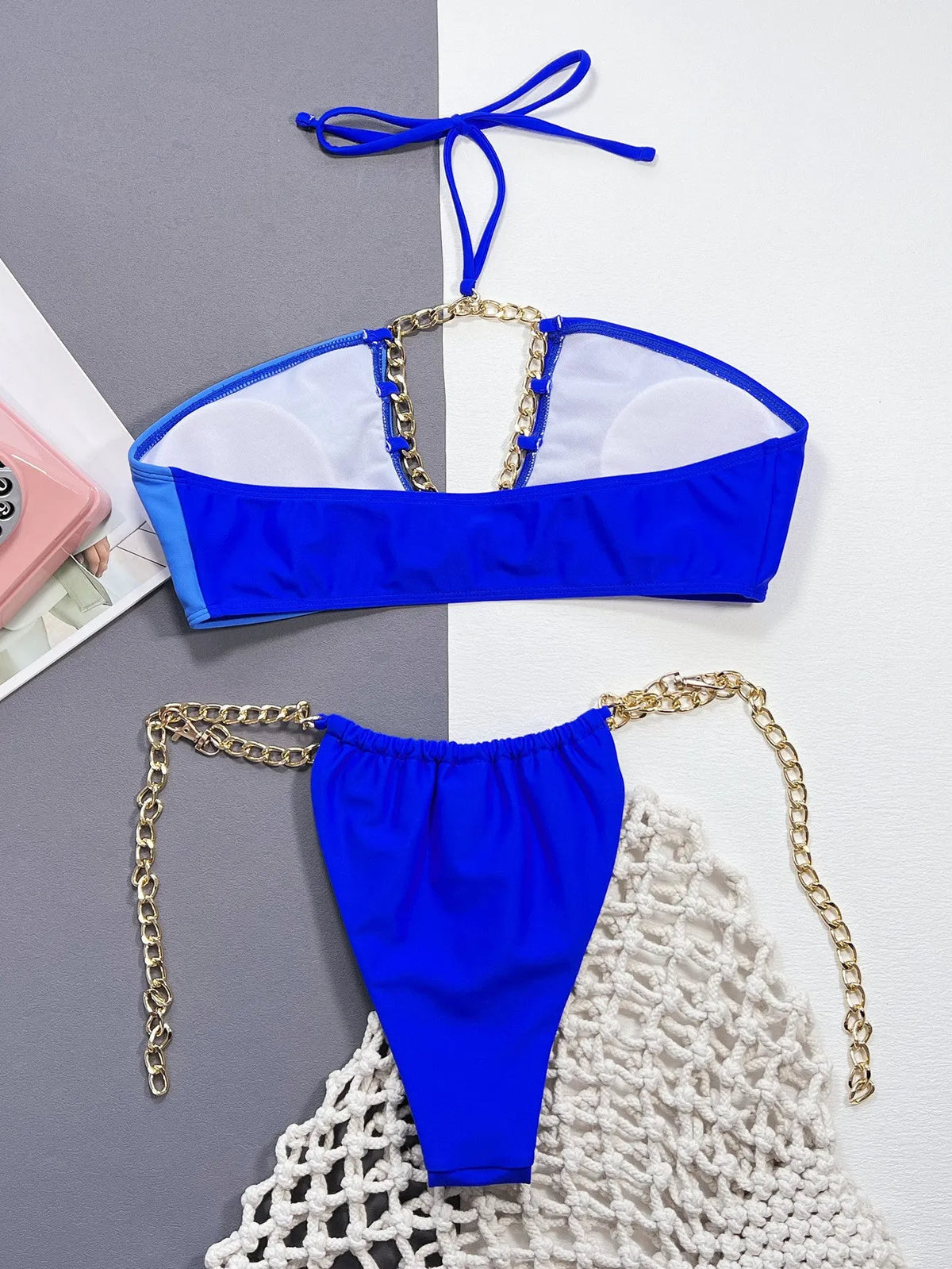 Solid blue women's nylon bikini swimsuit laid flat showing two-piece design