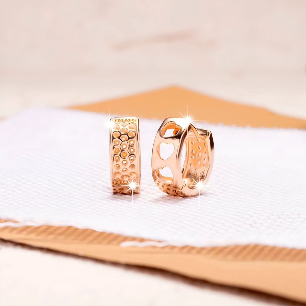 Rose gold electroplated earrings with three hollowed heart designs in circular shape