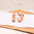 Rose gold electroplated earrings with three hollowed heart designs in circular shape