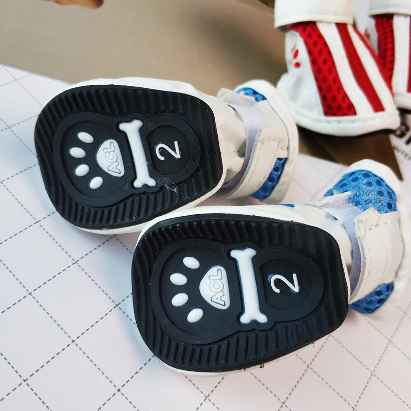 Set of four blue cloth dog shoes for small dogs with non-slip soles and a zip fastening.
