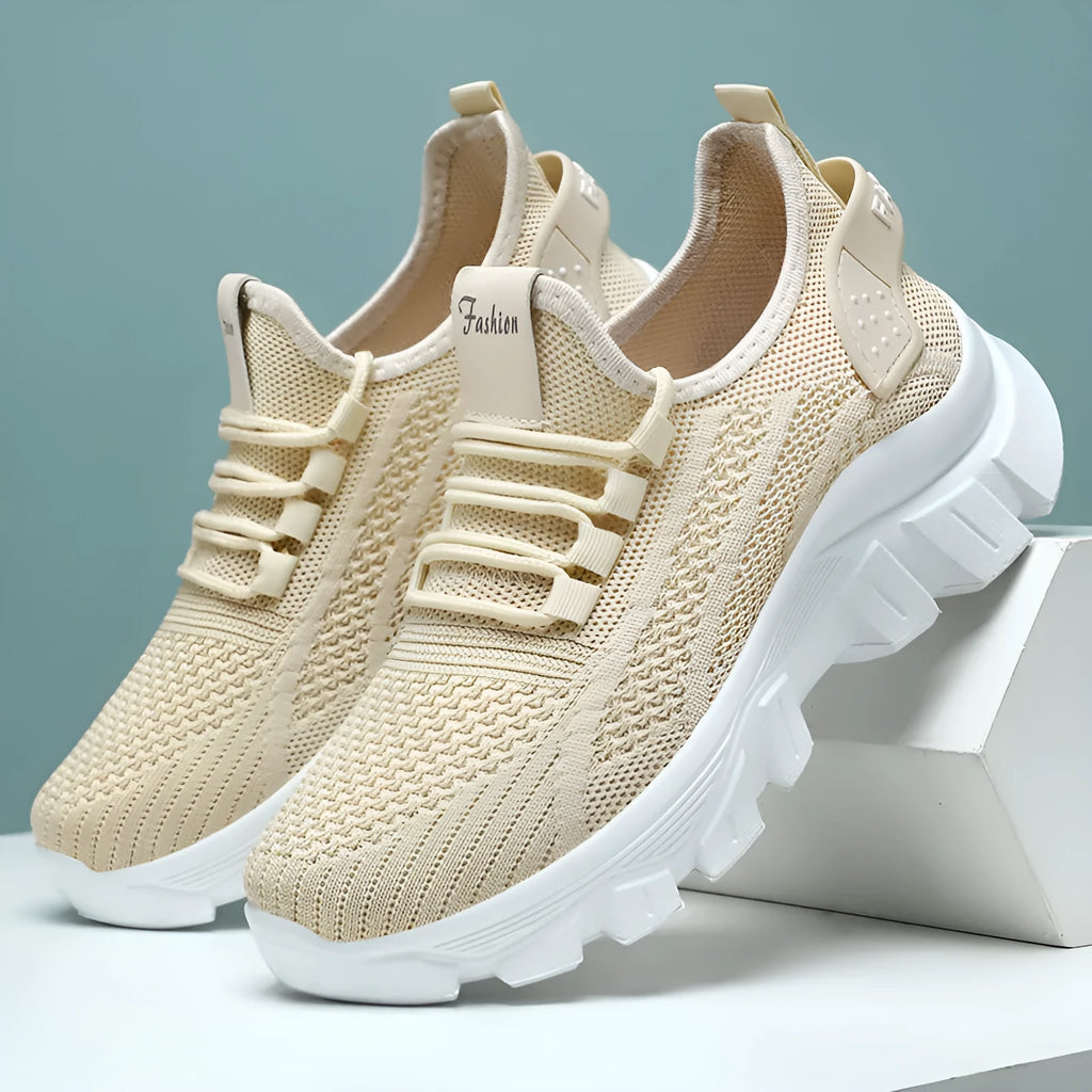 Women's white Flyknit sneakers with a thick PVC sole and lace-up front.