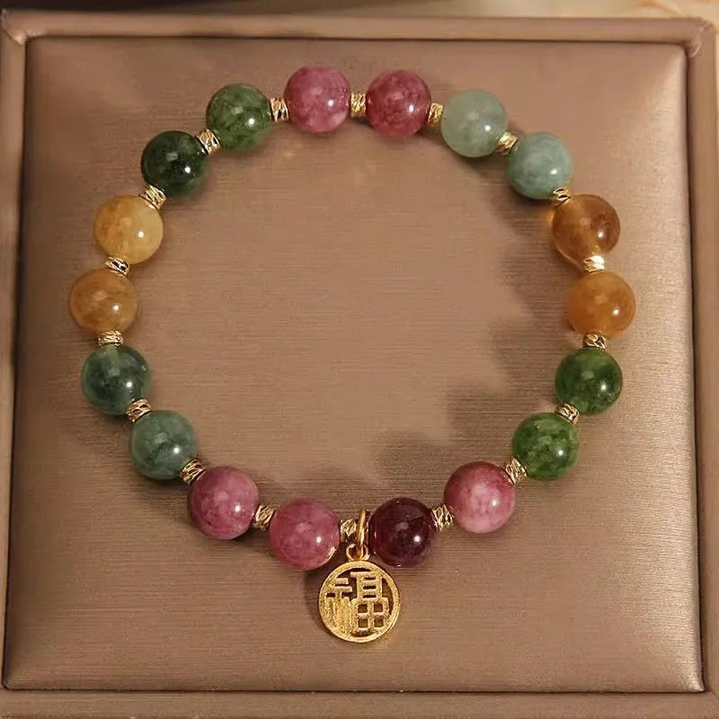 Natural colour tourmaline bracelet with floral and fu character designs and electroplated finish
