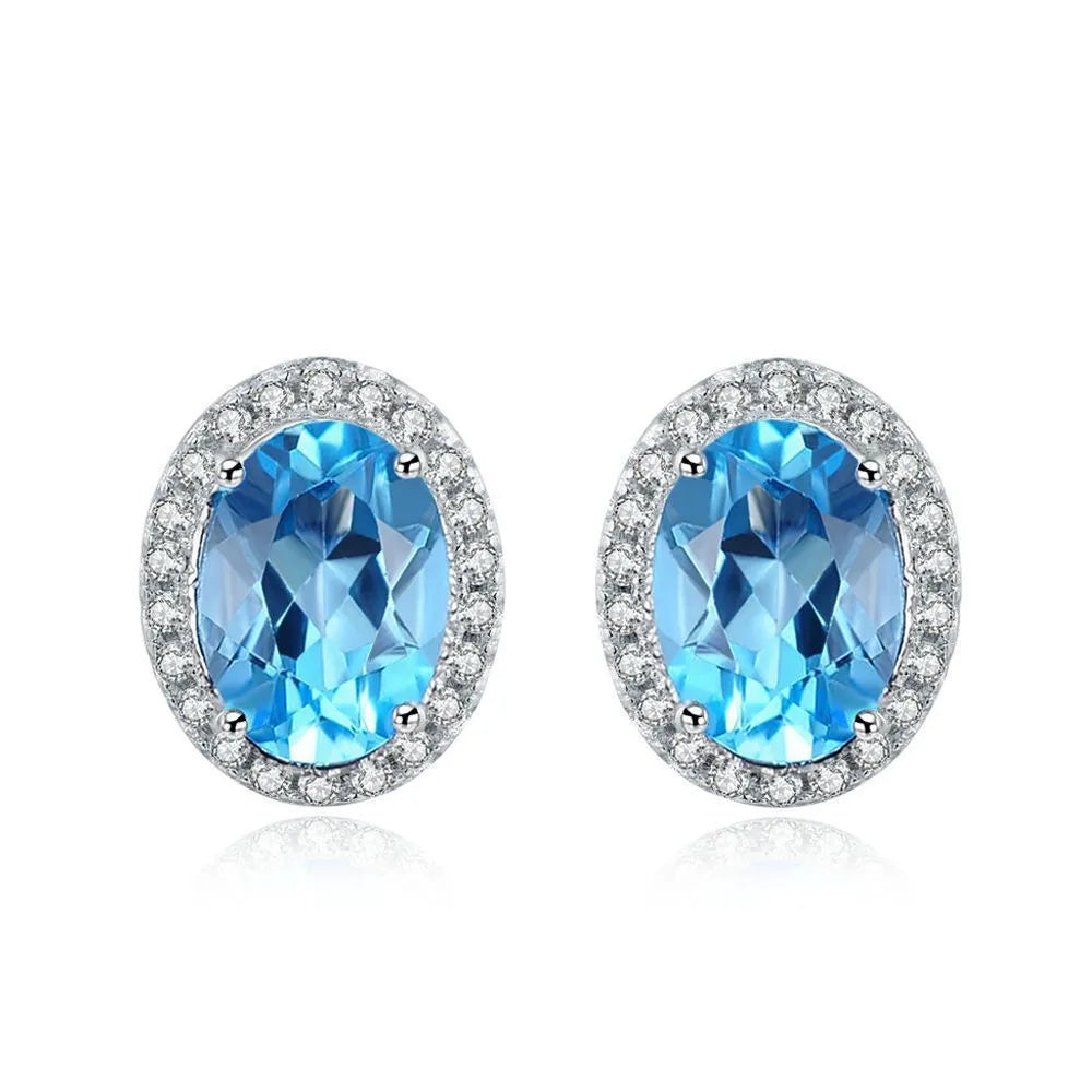 925 sterling silver jewellery set with blue topaz gems showing earrings, ring, pendant and necklace with geometric design