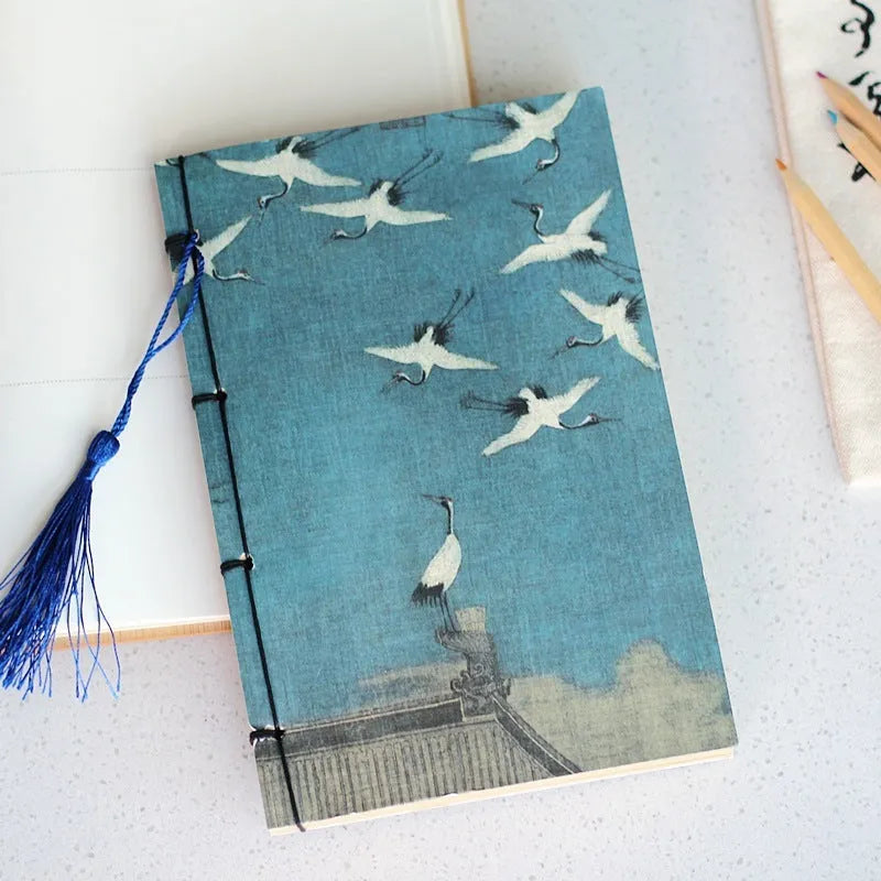 A5 antique wire-bound notebook with retro painting cover, thread binding, and black tassels.