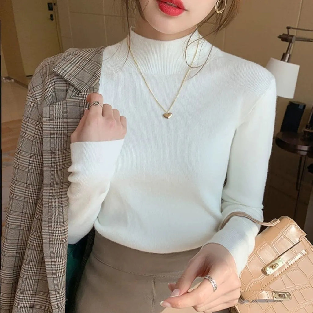 Women's slim fit long sleeve knitted top in viscose fibre shown in apricot colour.