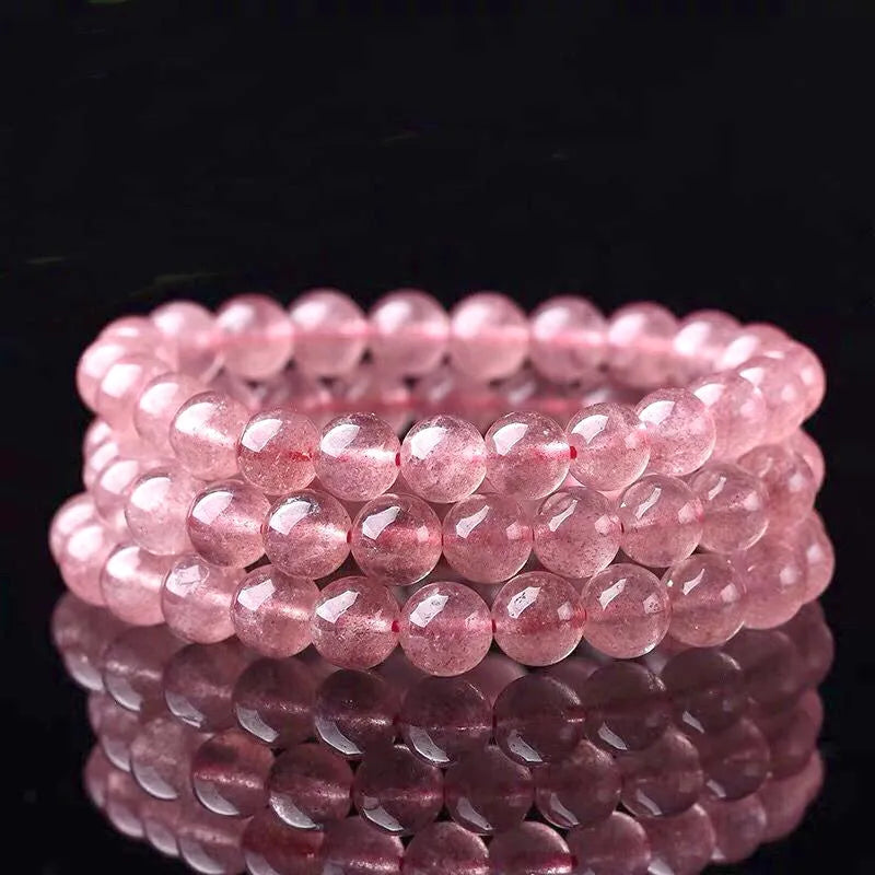 Women's strawberry quartz crystal bracelet with polished round beads.