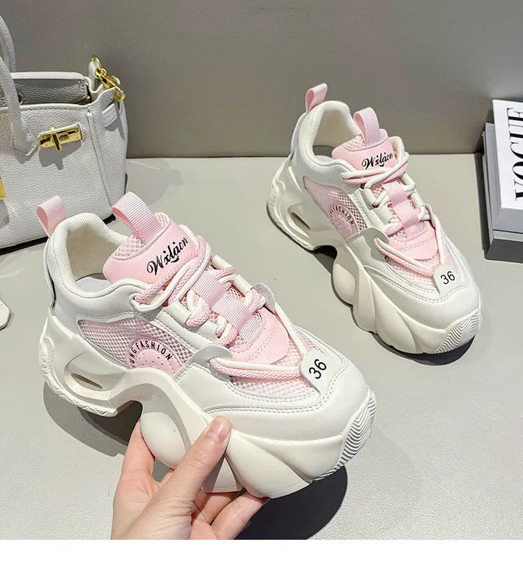 Women's pink thick sole sneakers with cross straps and breathable mesh lining on a white background.