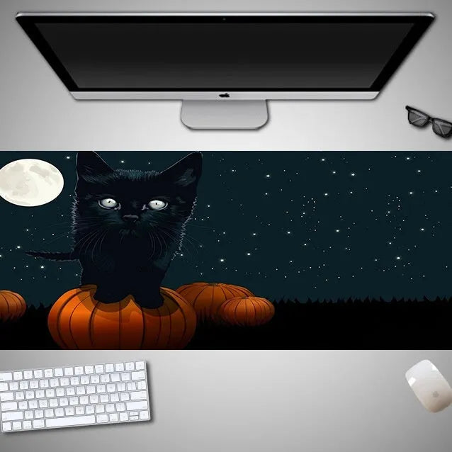 Oversized Halloween-themed rubber cloth mouse pad with non-slip base on a desk.