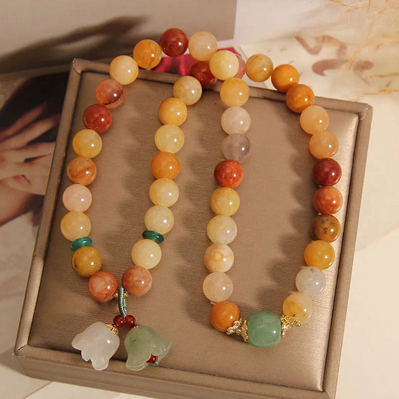 Natural Jinsi Jade multi-layer bracelet for women with orchid pendant on green background