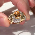 Gold-coloured copper ring with an embossed feather pattern and inlaid yellow zircon stones.