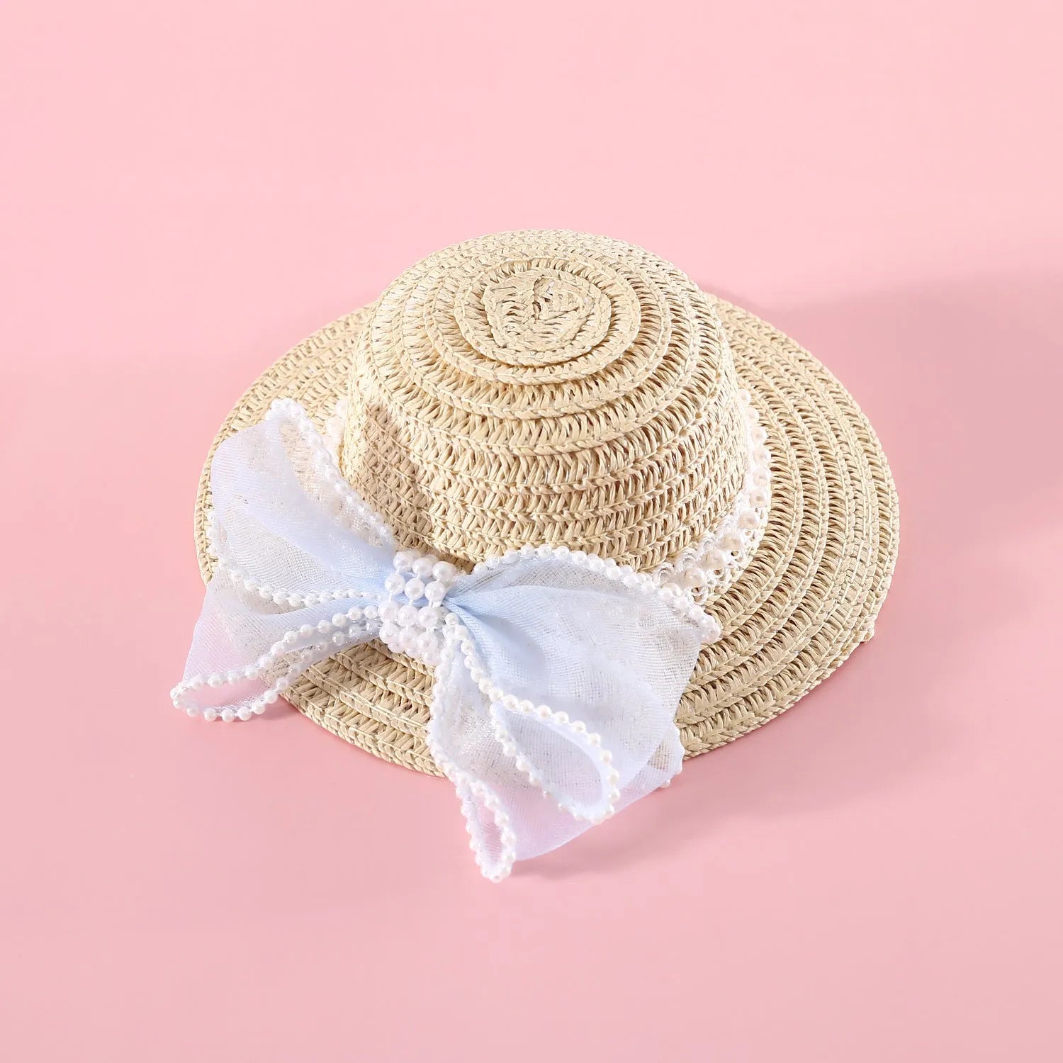 Cat wearing a woven Lafite leaves straw hat with a blue pearl butterfly bow.