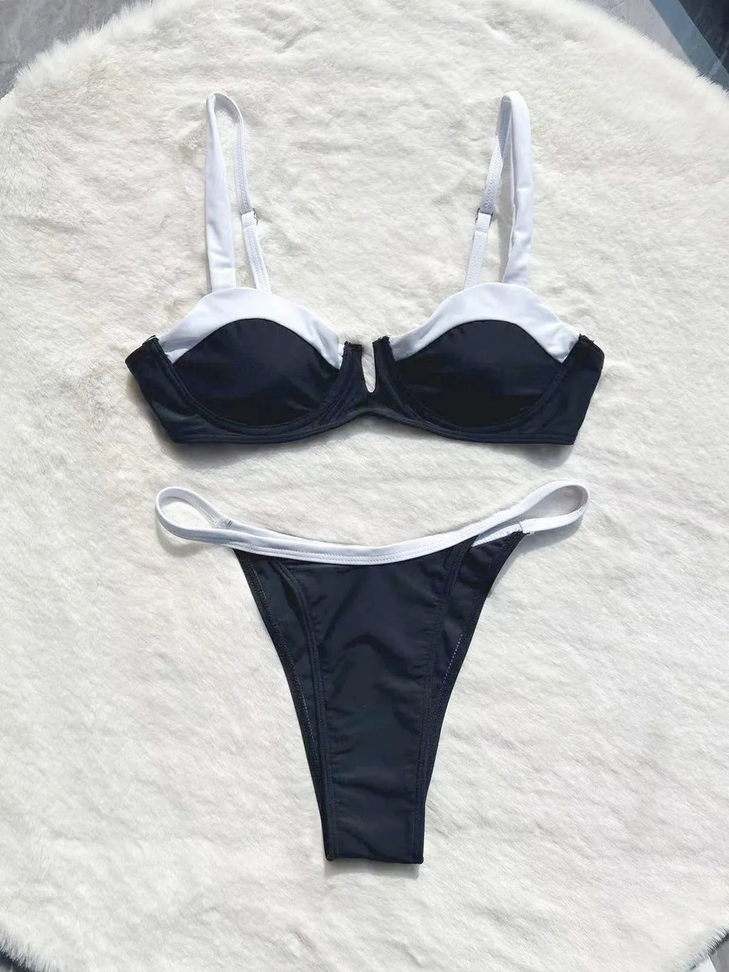 Black women's low waist bikini swimsuit with split sides and stitching detail
