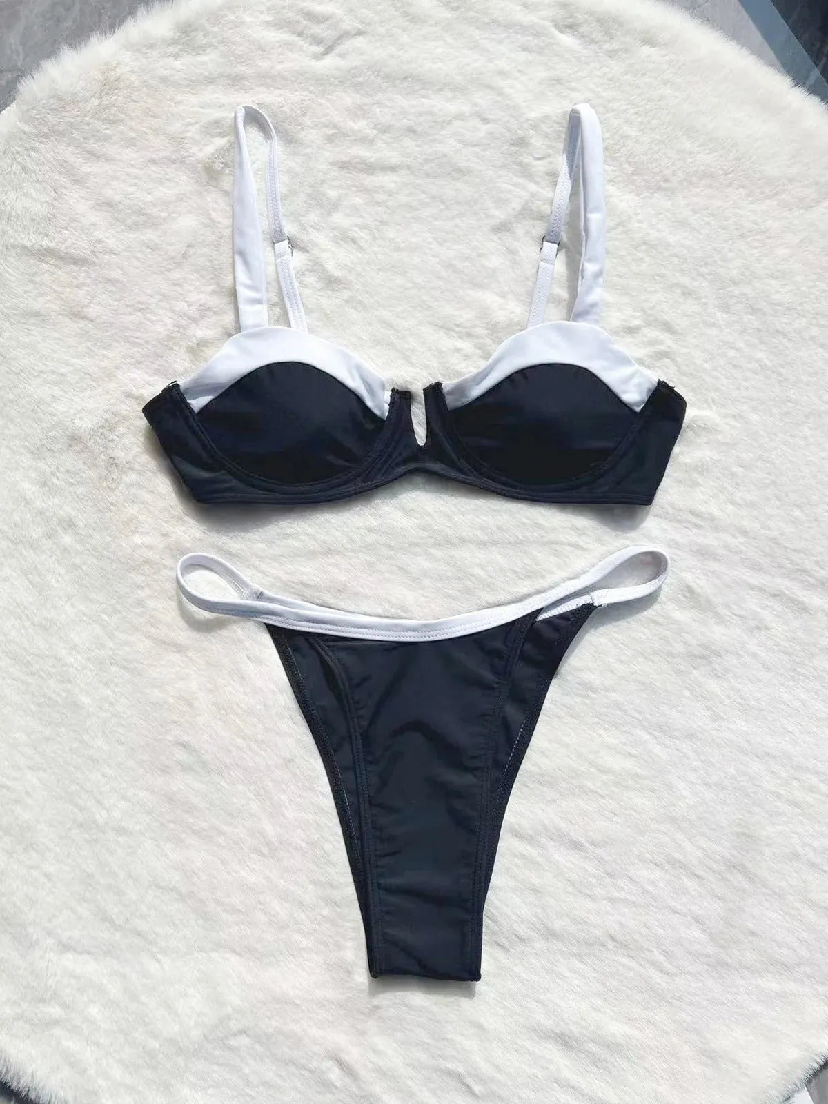 Black women's low waist bikini swimsuit with split sides and stitching detail