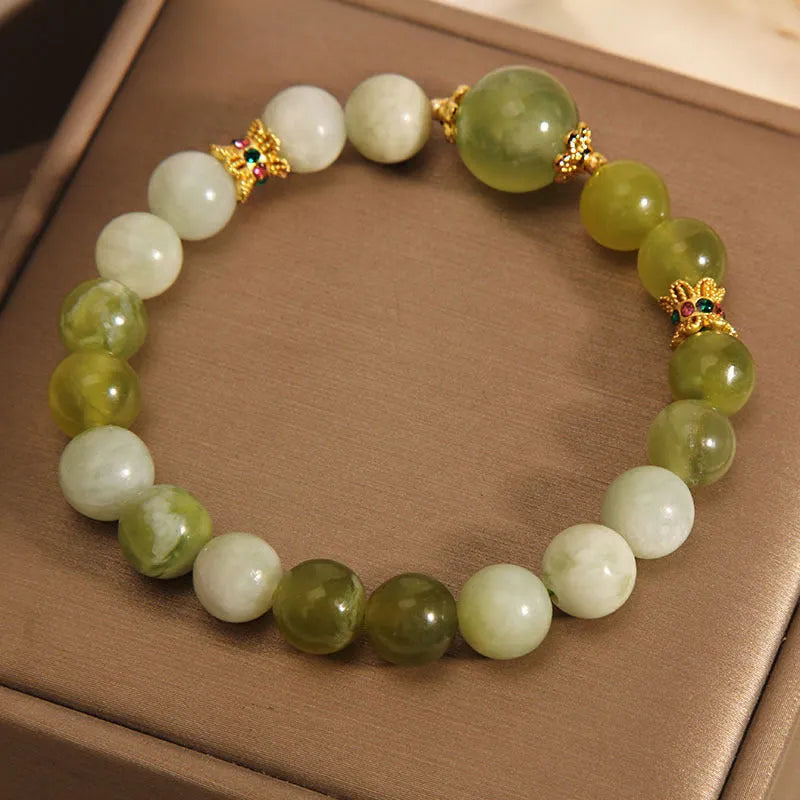 Women's bracelet made of natural green Xiuyan jade in a sweet Mori style.