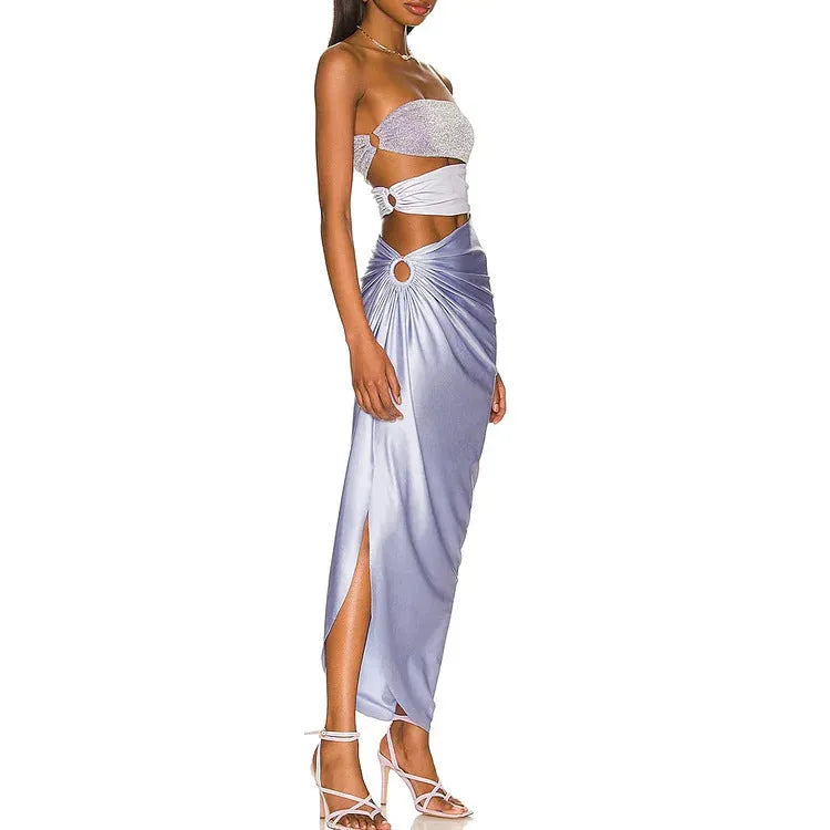 Purple one-piece swimsuit with hollow design and matching wrap skirt on a model.