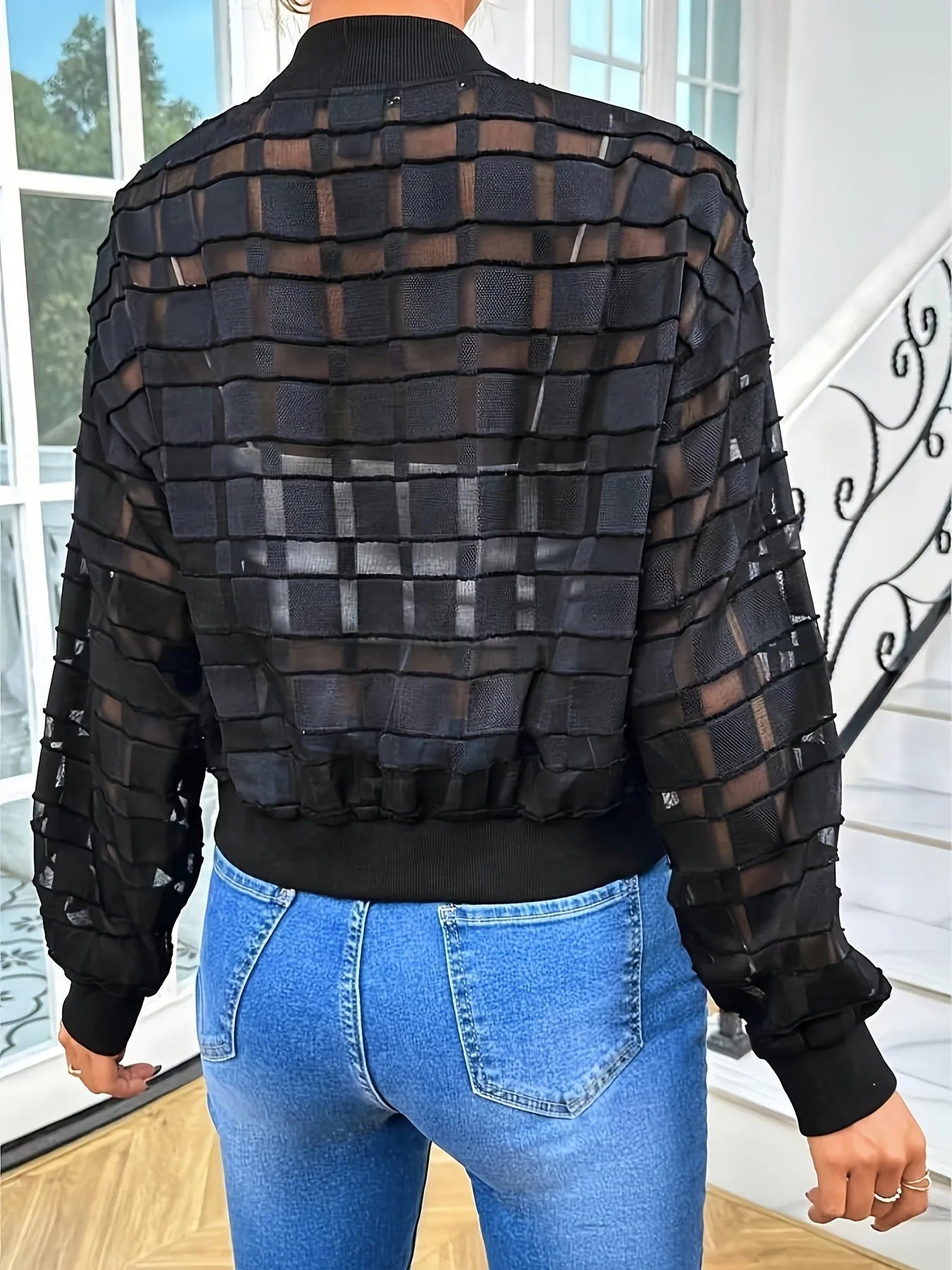 Black women's casual jacket with semi-transparent geometric pattern and zip front.