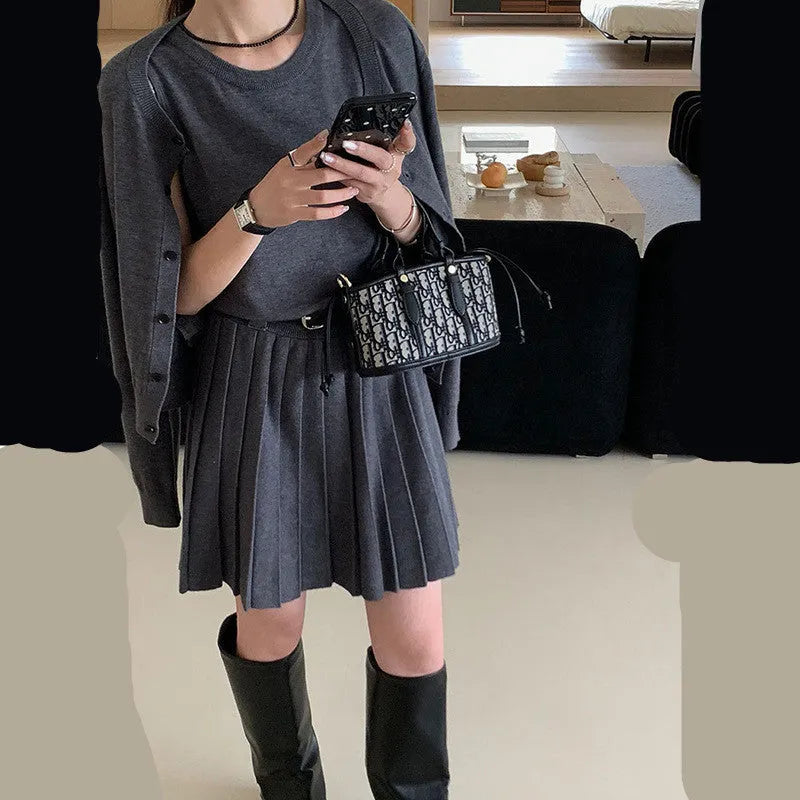 Grey art retro women's vest skirt and long-sleeve cardigan two-piece set with pleats and belt.