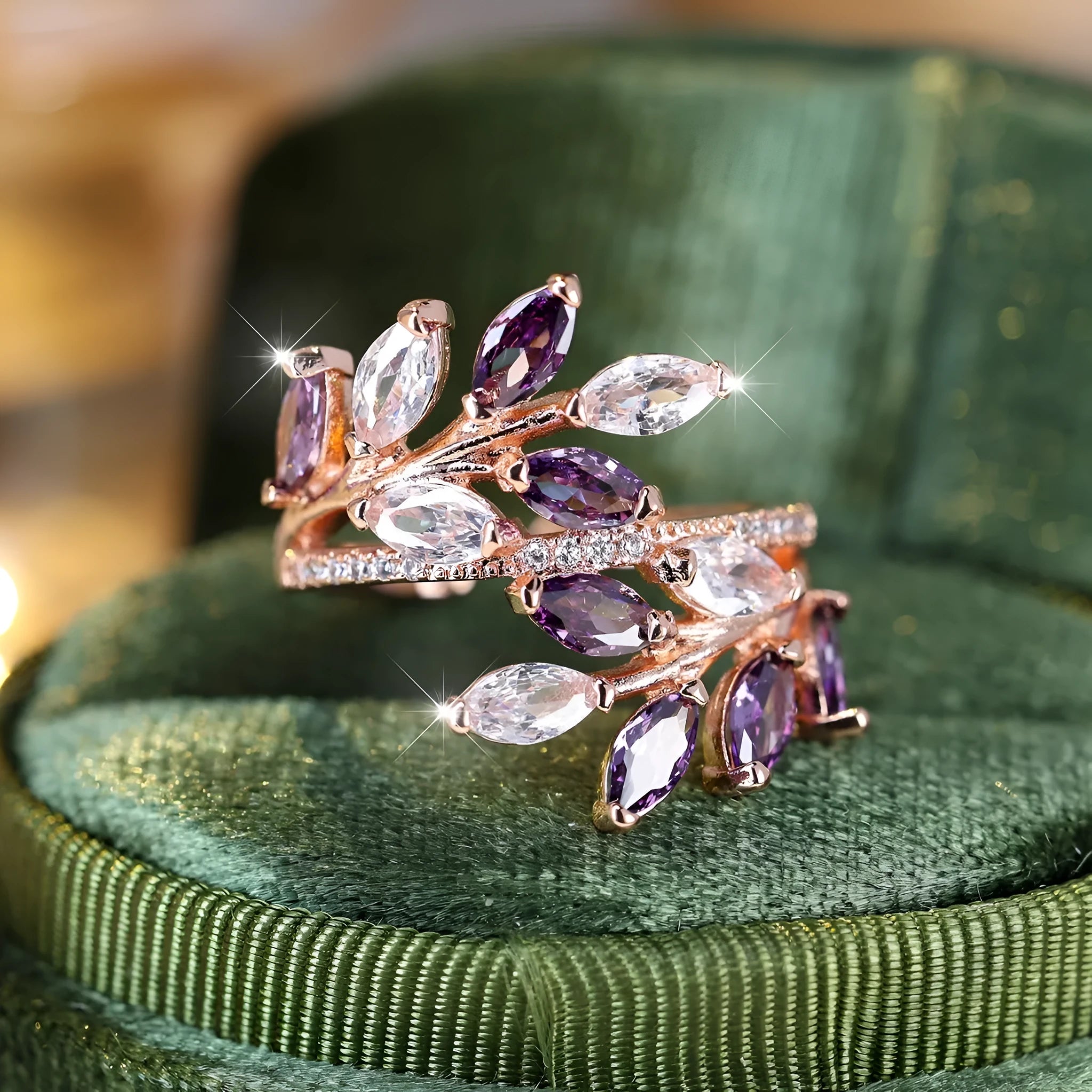 Adjustable opening copper leaf fashion ring with sparkling zirconia stones in a rose gold finish.