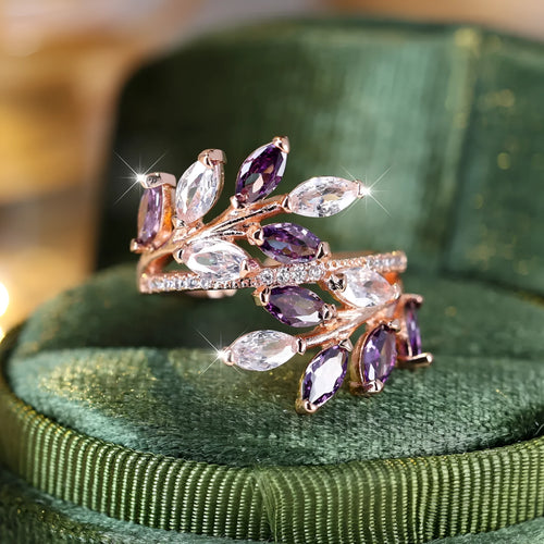 Adjustable opening copper leaf fashion ring with sparkling zirconia stones in a rose gold finish.