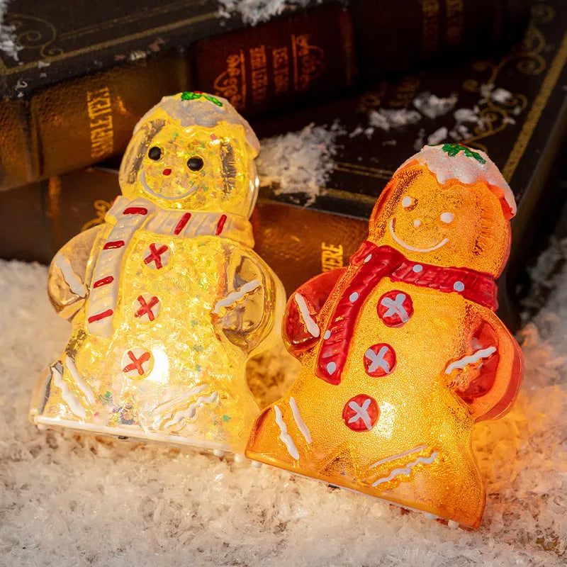 Glowing gingerbread man Christmas ornament with LED light and red scarf, measuring 6.5cm wide by 10.5cm tall