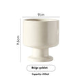 A hand-pinched irregular shaped ceramic mug in a solid colour, shown on a plain background.