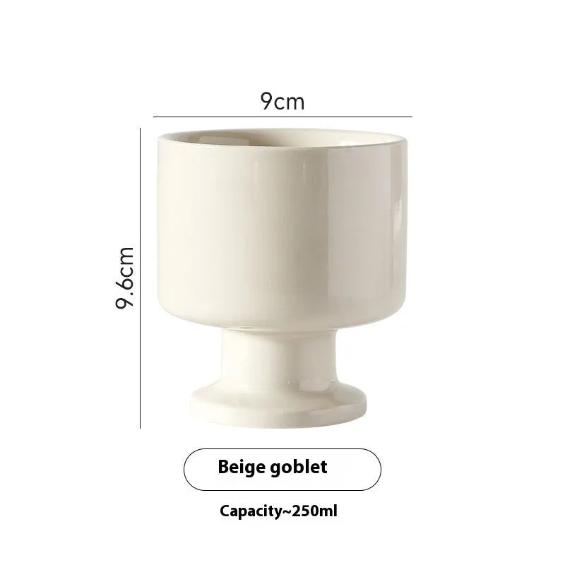 A hand-pinched irregular shaped ceramic mug in a solid colour, shown on a plain background.