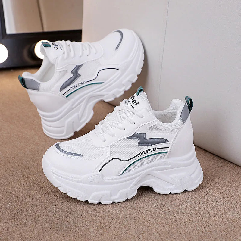 Women's white height increasing dad shoes with cross straps and lace-up front on rubber sole.