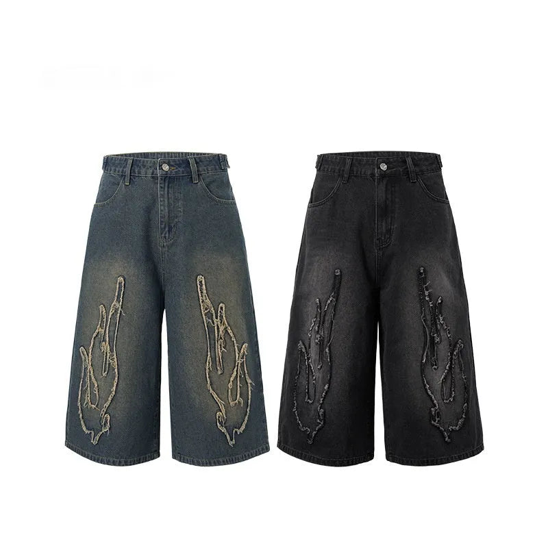 Men's black cropped denim shorts with flame embroidery patch and straight-leg cut
