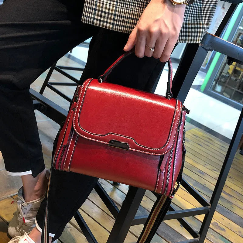 Women's genuine leather messenger bag in retro styling with multiple internal compartments