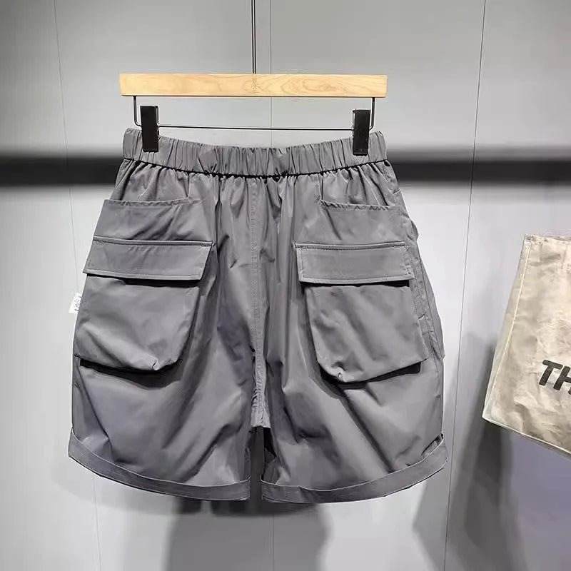 Men's loose fit black casual shorts with pockets and straight leg hem.